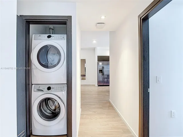 a view of a hallway with washer and dryer