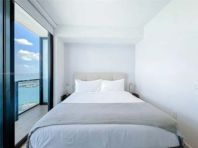 a bedroom with a bed and a mirror