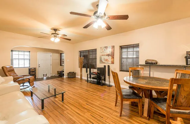 a living room with furniture a table and a chandelier