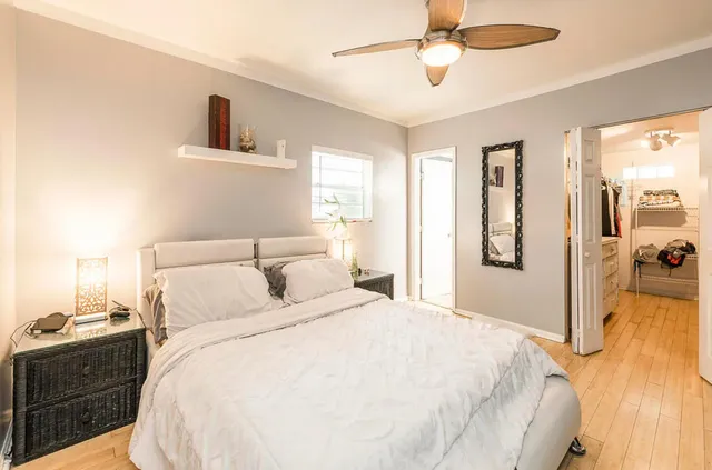 a spacious bedroom with a bed and a chandelier
