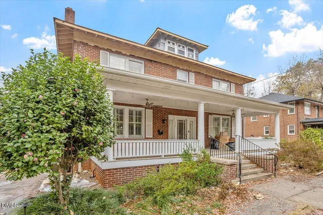 a view of a brick house with a yard