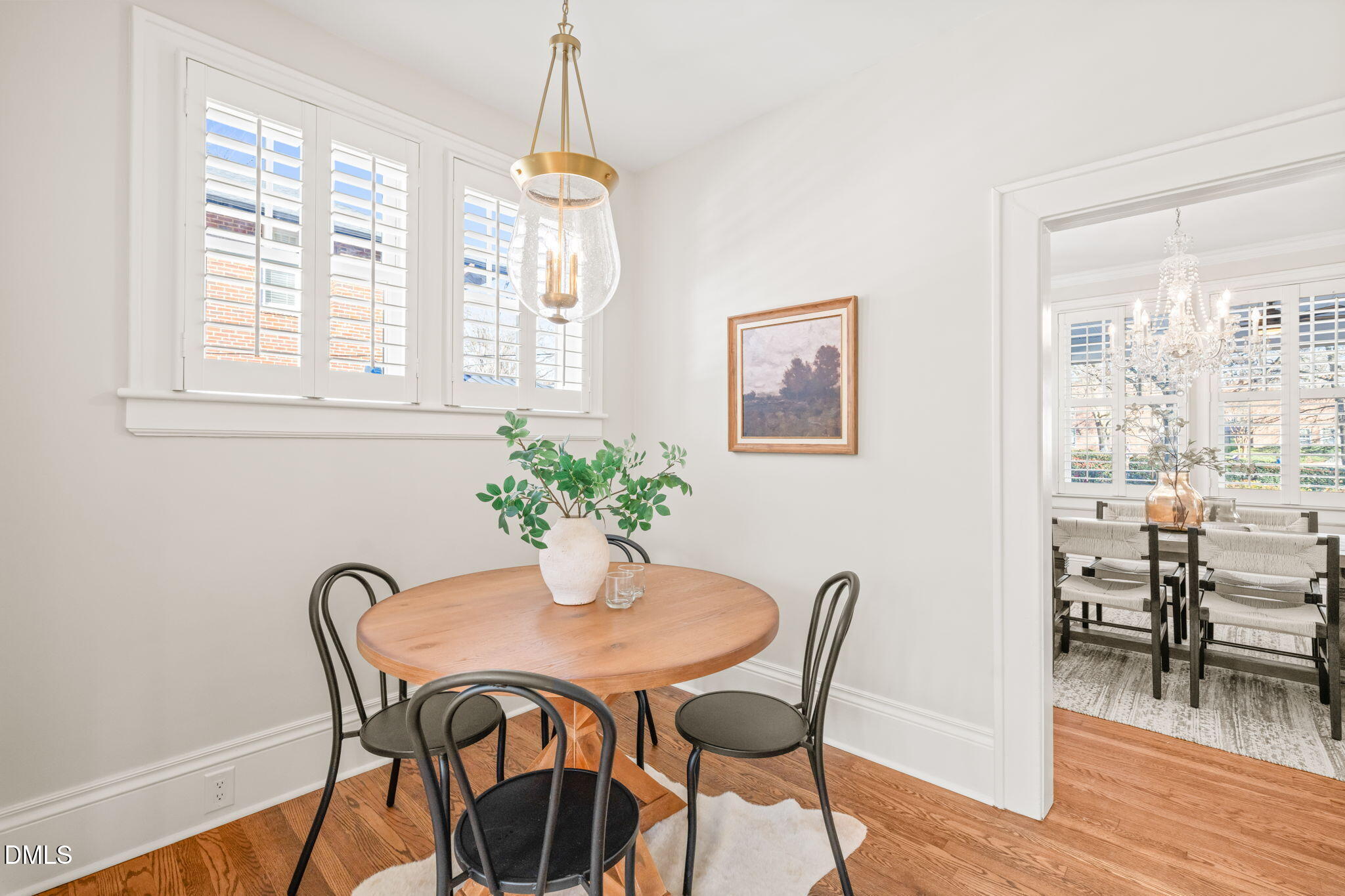 1617 Glenwood Avenue Raleigh, NC 27608 - Photo 22 of 58 a dining room with furniture potted plants and wooden floor