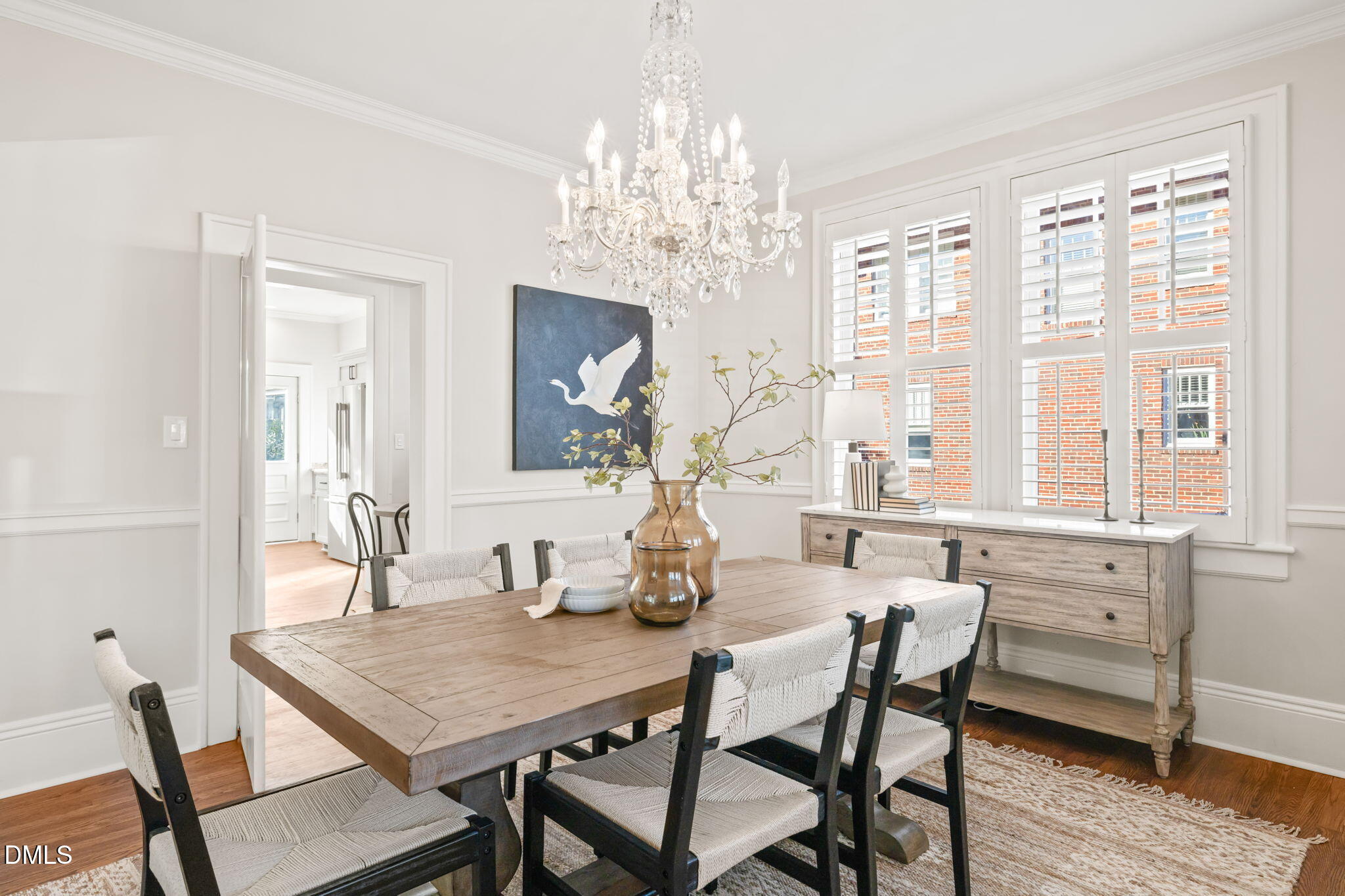 1617 Glenwood Avenue Raleigh, NC 27608 - Photo 23 of 58 a dining room with furniture a chandelier and wooden floor