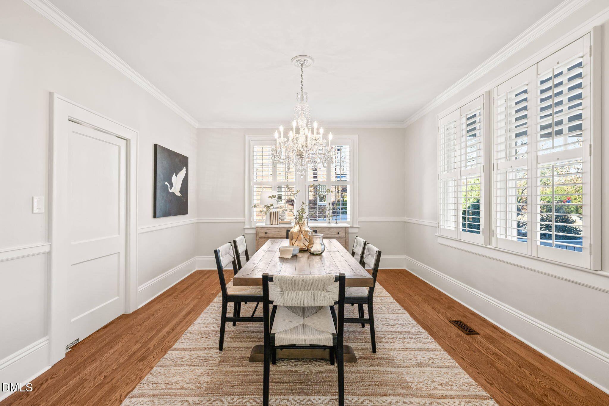 1617 Glenwood Avenue Raleigh, NC 27608 - Photo 24 of 58 a dining room with furniture a chandelier and wooden floor