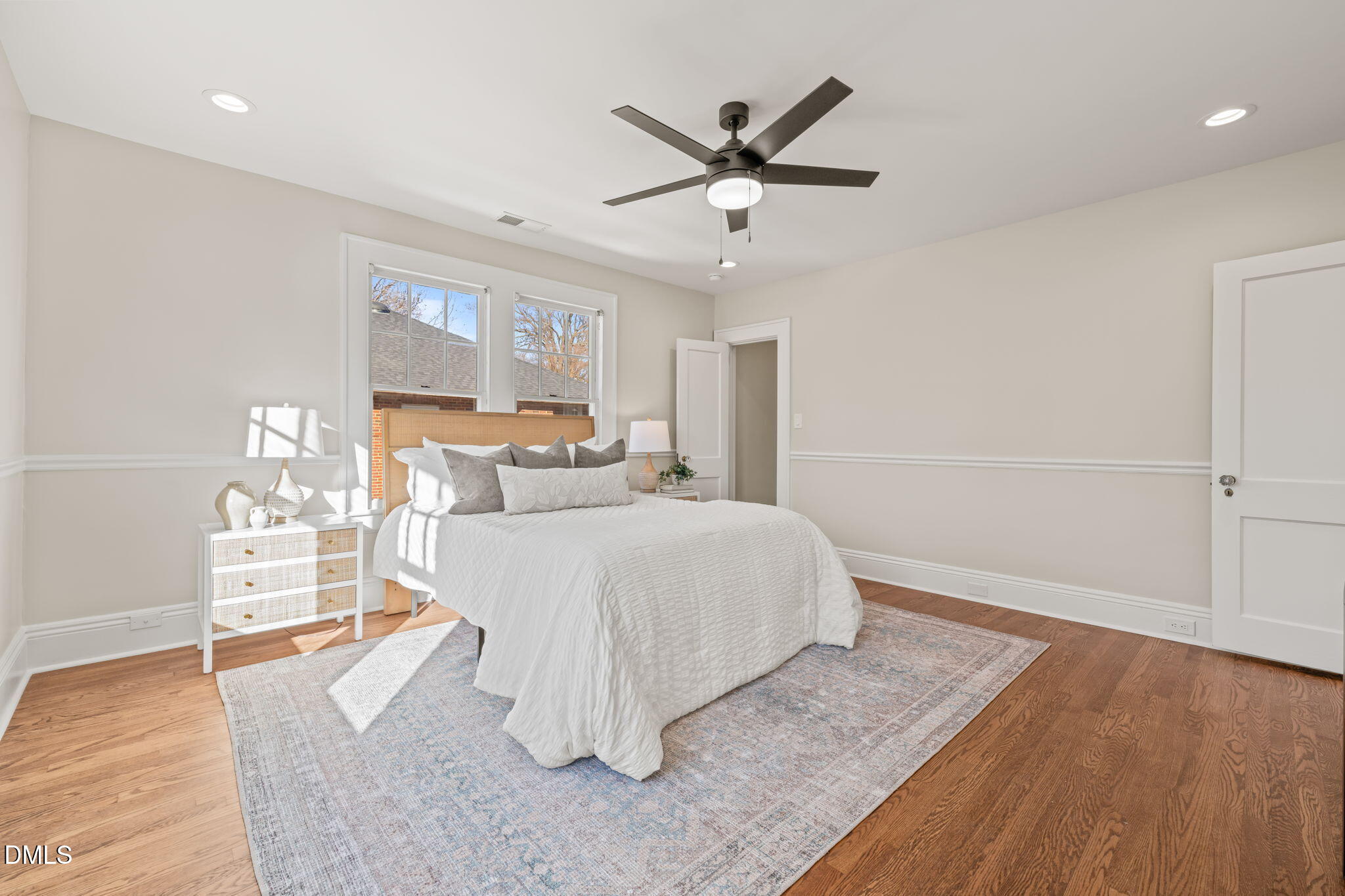 1617 Glenwood Avenue Raleigh, NC 27608 - Photo 30 of 58 a bedroom with a large bed and wooden floor