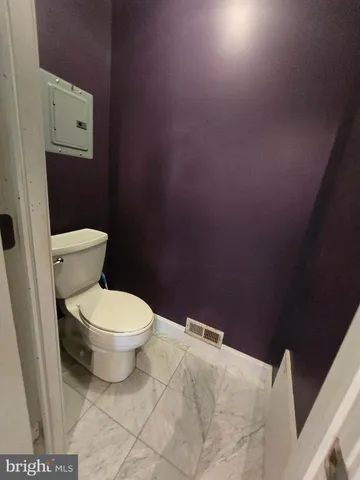 a white toilet sitting next to a shower