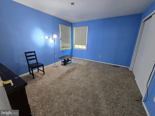 a view of a room with furniture and windows