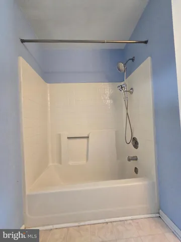 a bathroom with a shower and a bath tub