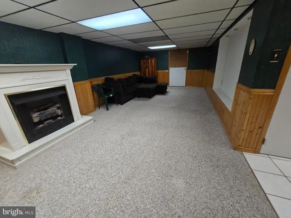 a view of a livingroom with furniture and a fireplace