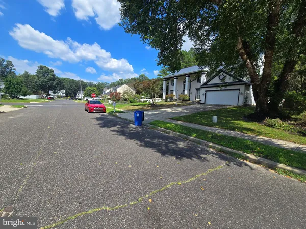 a view of house with outdoor space and parking