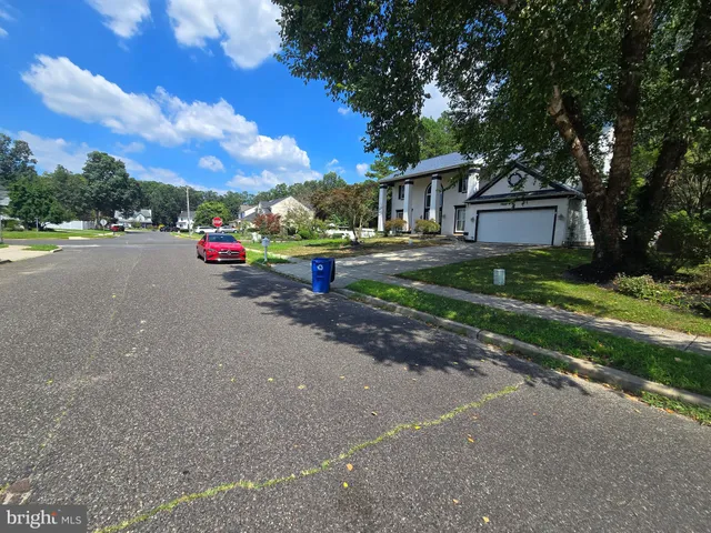 a view of house with outdoor space and parking