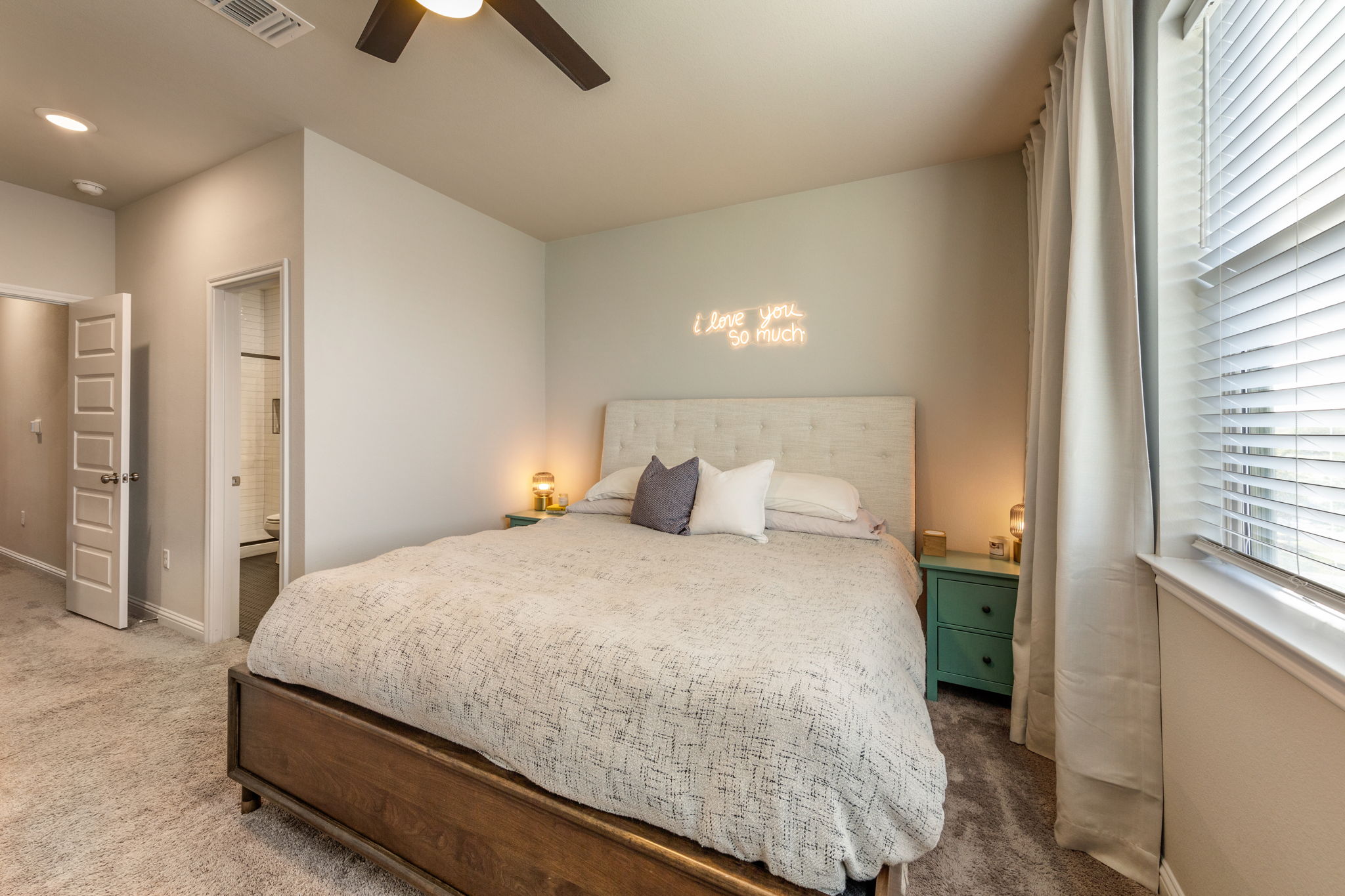 7812 Moody Bend, Unit 38 Austin, TX 78744 - Photo 17 of 39 a bedroom with a bed and ceiling fan