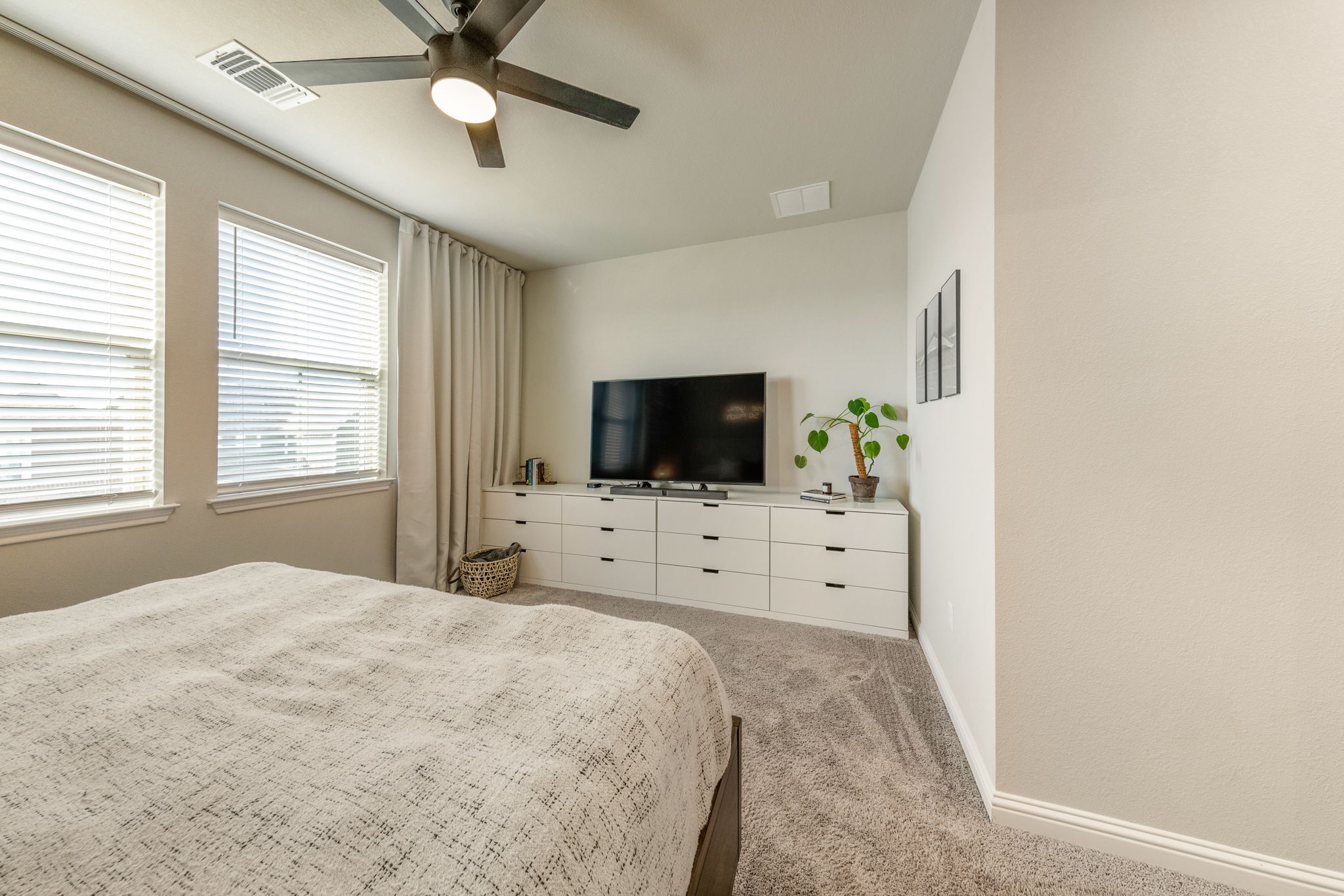 7812 Moody Bend, Unit 38 Austin, TX 78744 - Photo 18 of 39 a bedroom with a bed and flat screen tv
