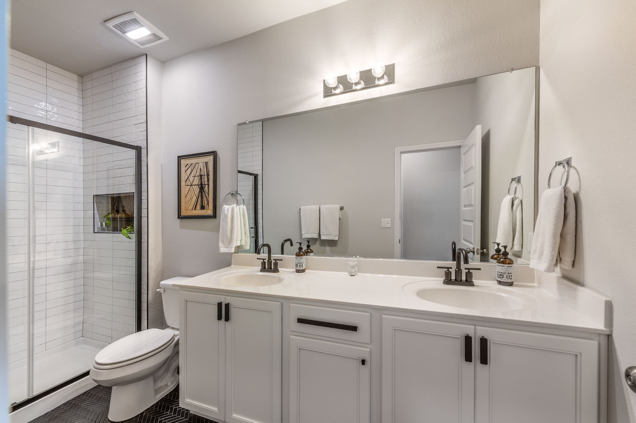 7812 Moody Bend, Unit 38 Austin, TX 78744 - Photo 19 of 39 a bathroom with a toilet sink and mirror
