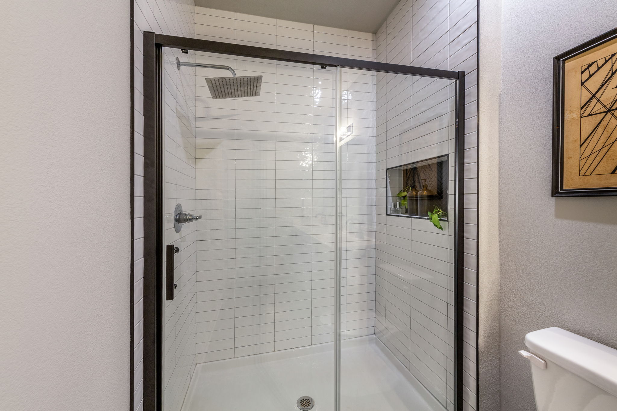 7812 Moody Bend, Unit 38 Austin, TX 78744 - Photo 20 of 39 a bathroom with a shower and a toilet