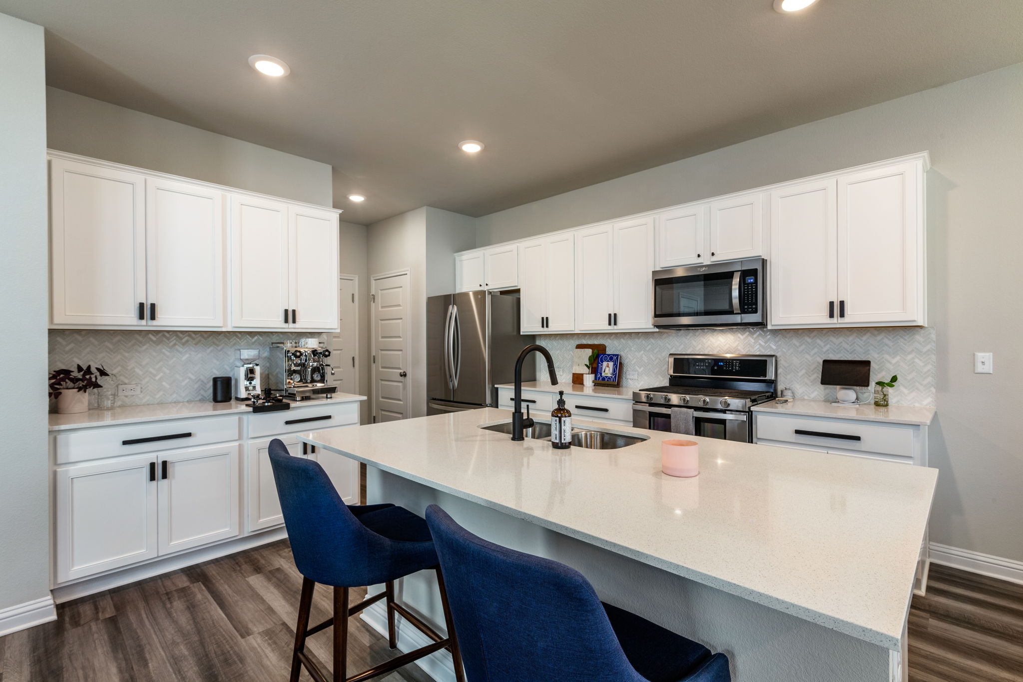 7812 Moody Bend, Unit 38 Austin, TX 78744 - Photo 2 of 39 a kitchen with stainless steel appliances a stove a sink a microwave a refrigerator a stove and white cabinets