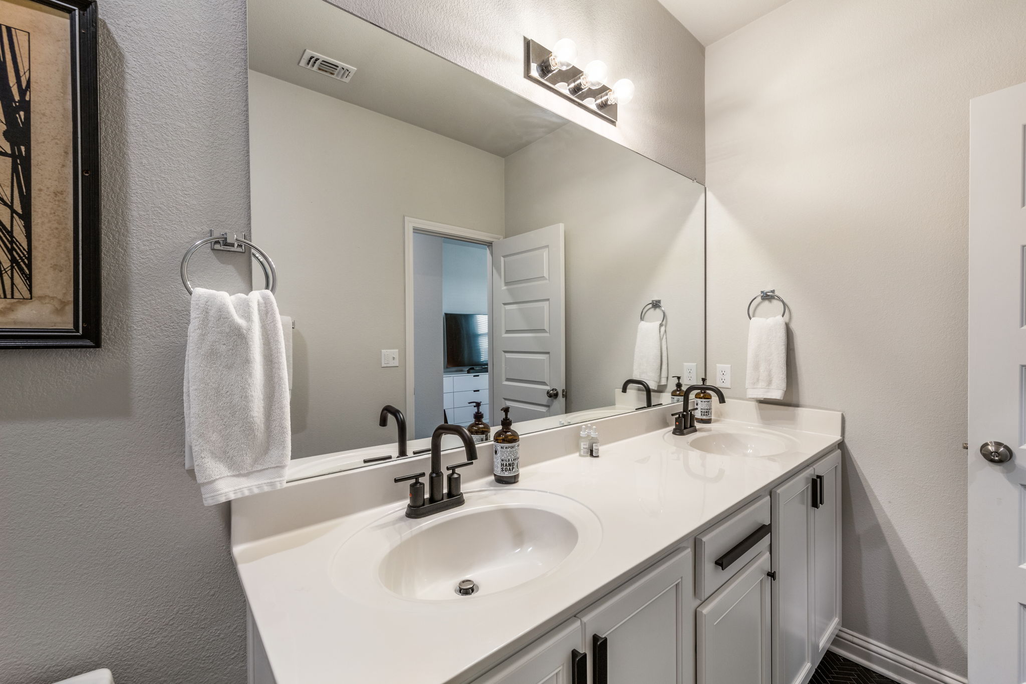 7812 Moody Bend, Unit 38 Austin, TX 78744 - Photo 21 of 39 a bathroom with a sink vanity and a mirror