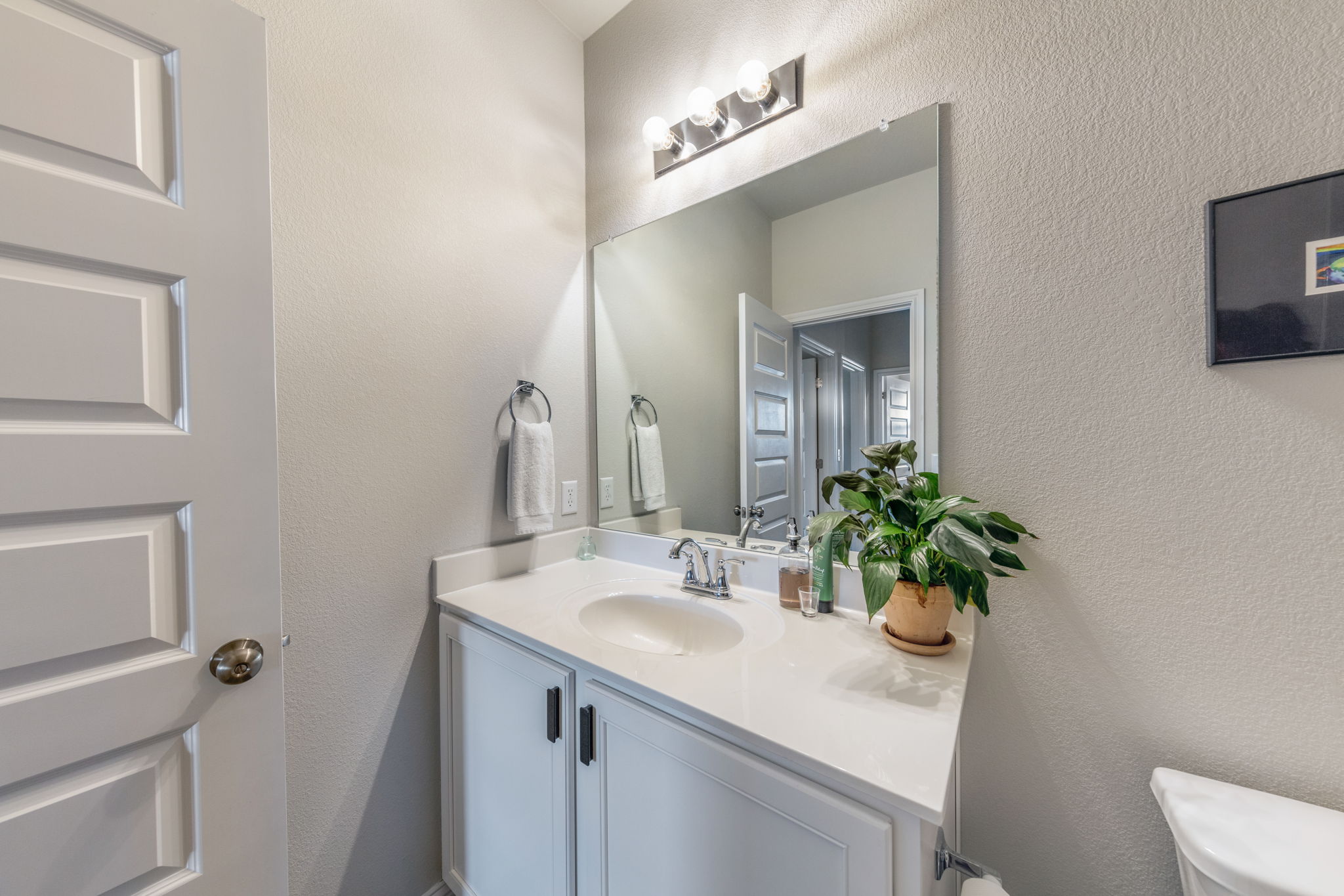 7812 Moody Bend, Unit 38 Austin, TX 78744 - Photo 24 of 39 a bathroom with a sink a toilet and mirror