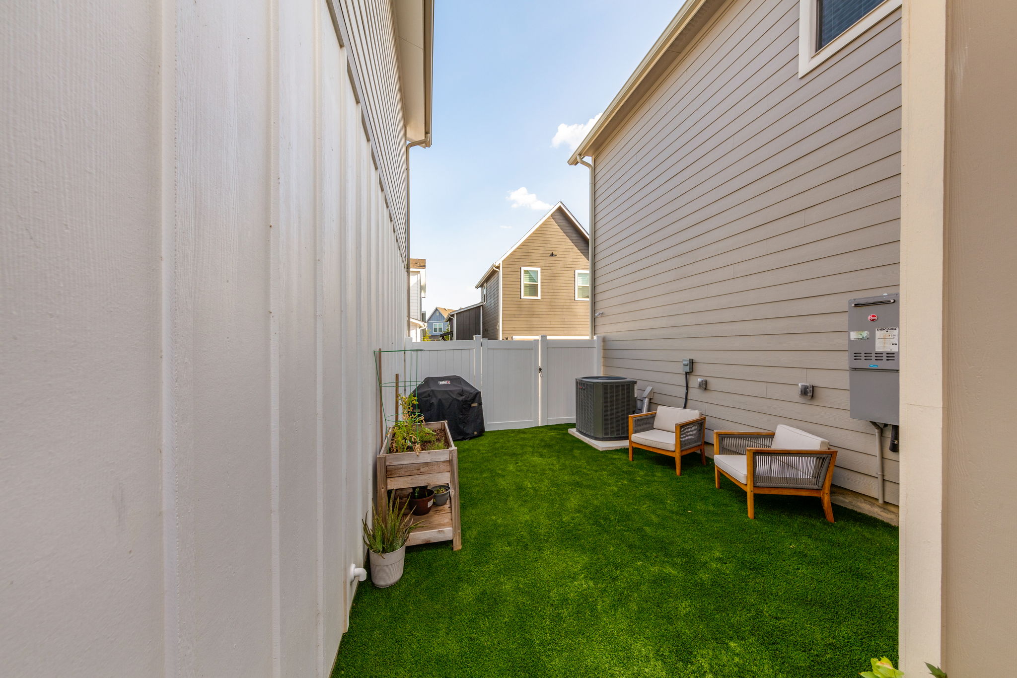 7812 Moody Bend, Unit 38 Austin, TX 78744 - Photo 34 of 39 a backyard of a house with wooden floor and fence