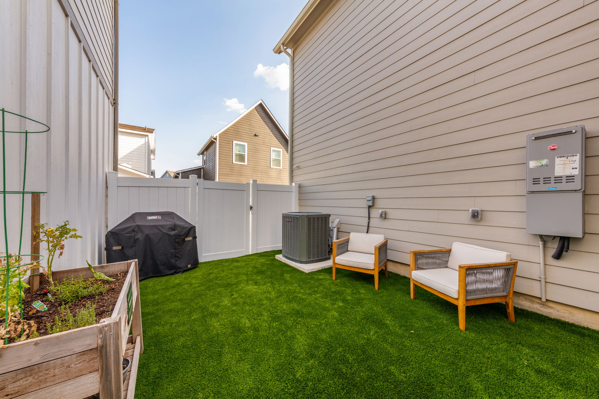 7812 Moody Bend, Unit 38 Austin, TX 78744 - Photo 35 of 39 a view of a backyard with table and chairs and potted plants