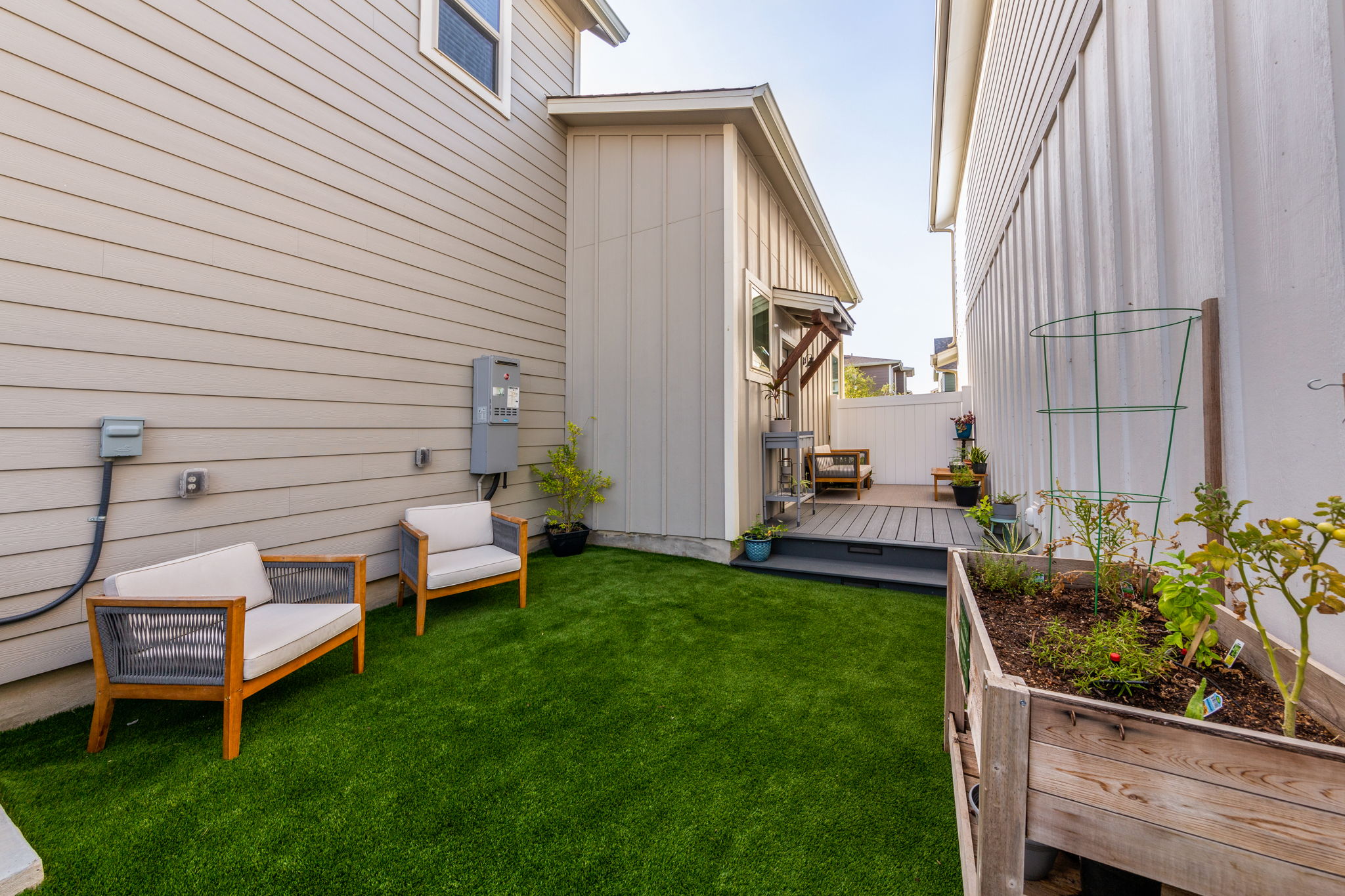 7812 Moody Bend, Unit 38 Austin, TX 78744 - Photo 5 of 39 a view of a backyard with chairs and plants