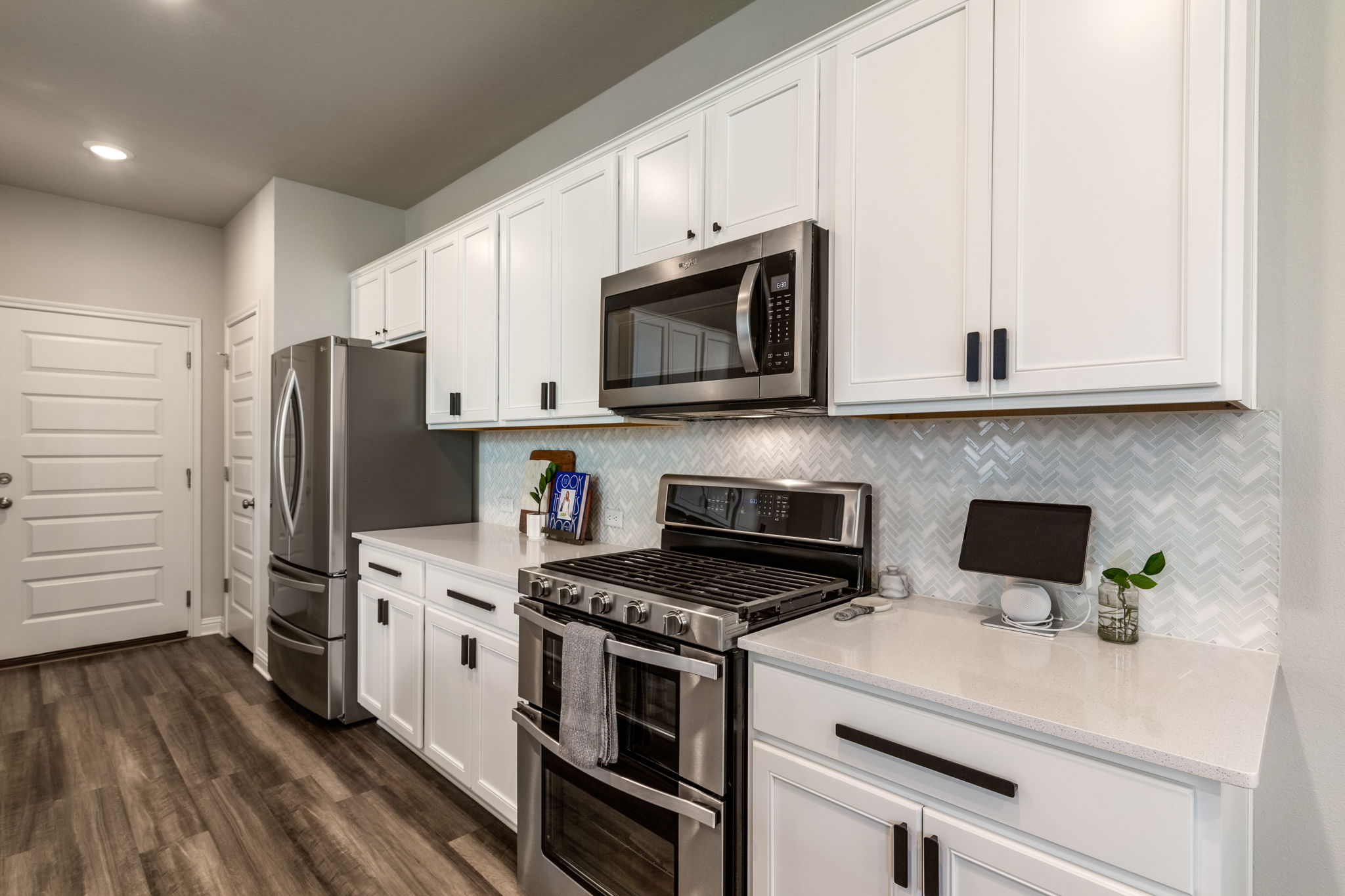 7812 Moody Bend, Unit 38 Austin, TX 78744 - Photo 10 of 39 a kitchen with stainless steel appliances white cabinets and a stove top oven