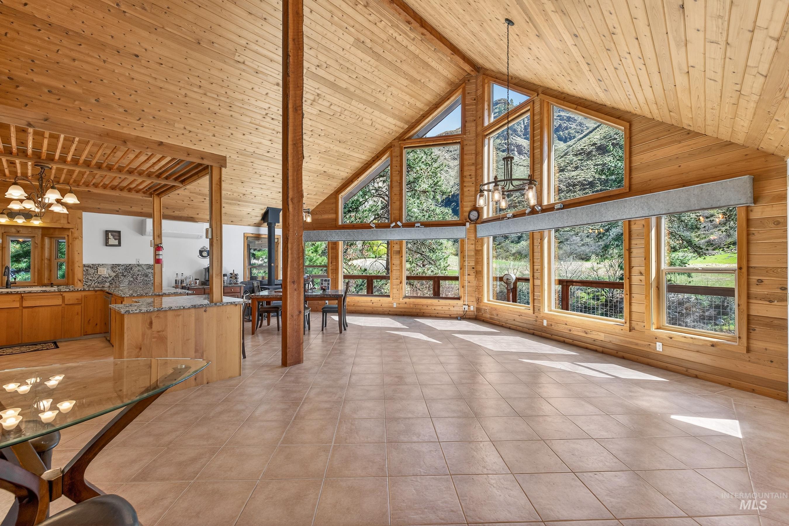 1352 South Main Street Riggins, ID 83549 - Photo 12 of 50 Unfurnished sunroom with beamed ceiling and suspended lighting