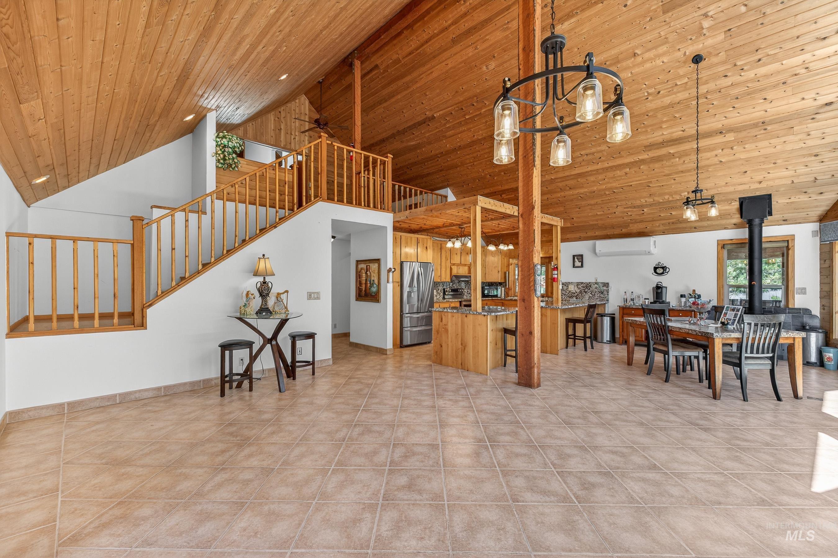 1352 South Main Street Riggins, ID 83549 - Photo 50 of 50 Kitchen with a wood stove, a ceiling fan, a breakfast bar, open floor plan, and a vaulted wooden ceiling