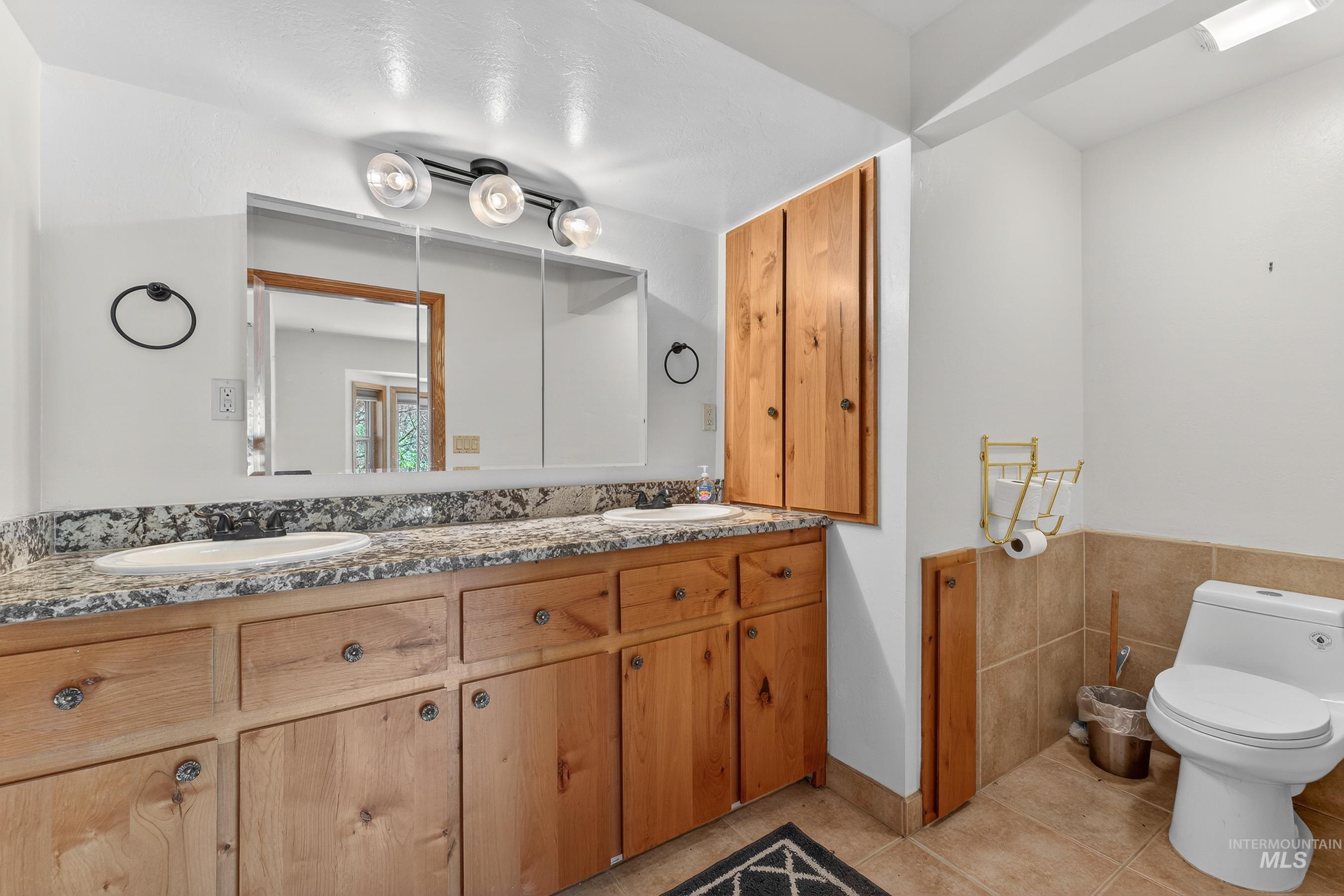 1352 South Main Street Riggins, ID 83549 - Photo 20 of 50 Full bathroom featuring double vanity, light tile patterned floors, and tile walls