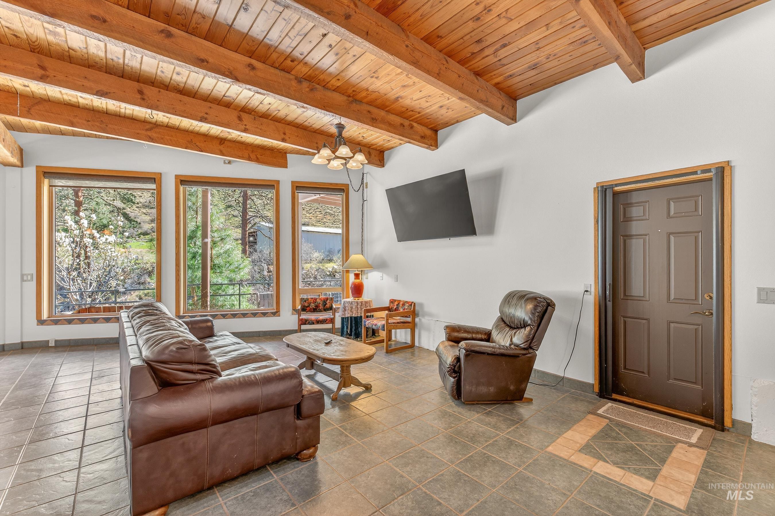 1352 South Main Street Riggins, ID 83549 - Photo 25 of 50 Living room with a wooden ceiling with exposed beams and suspended lighting