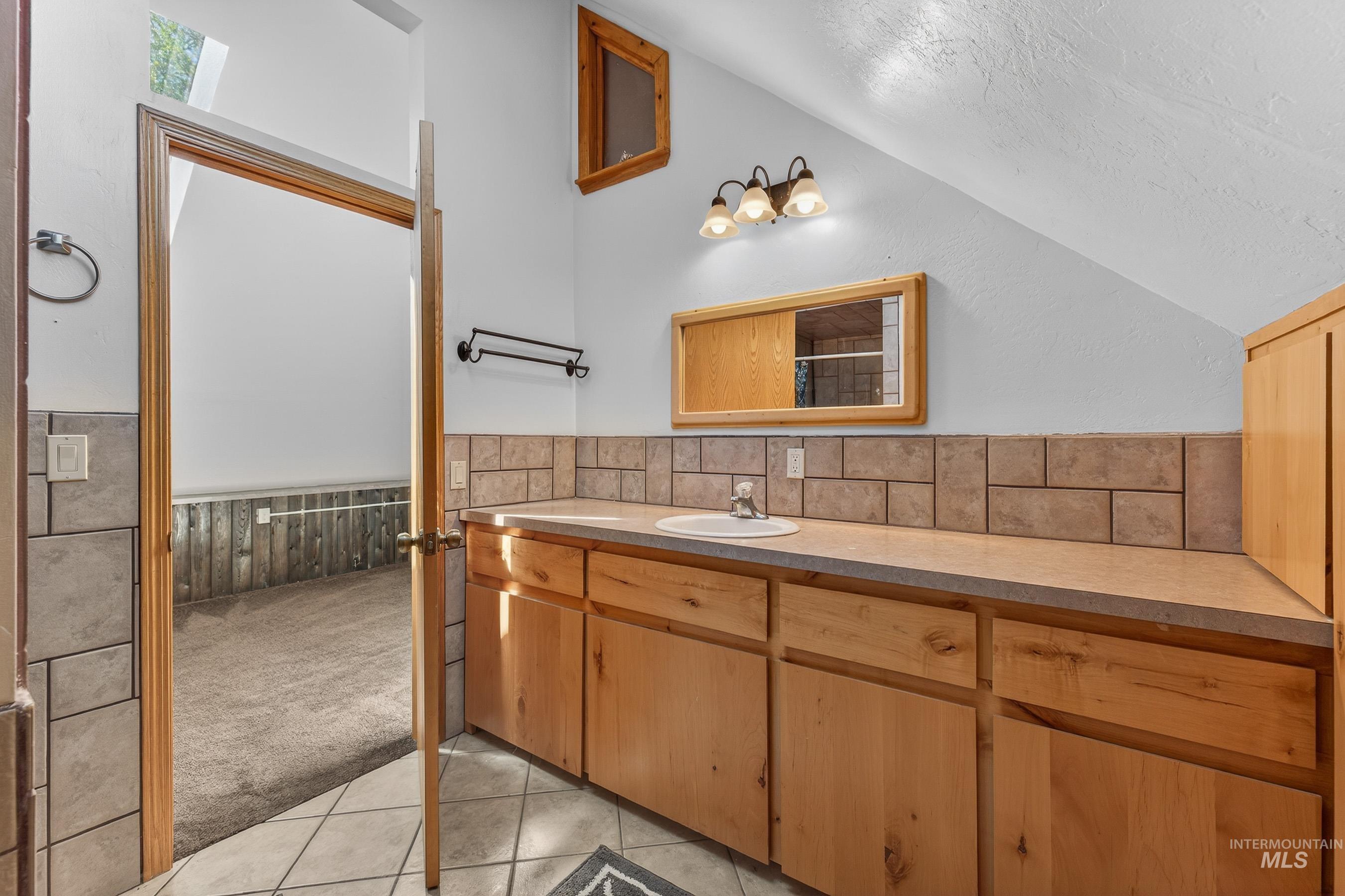 1352 South Main Street Riggins, ID 83549 - Photo 34 of 50 Full bath featuring vanity, light tile patterned floors, a wainscoted wall, light carpet, and a shower