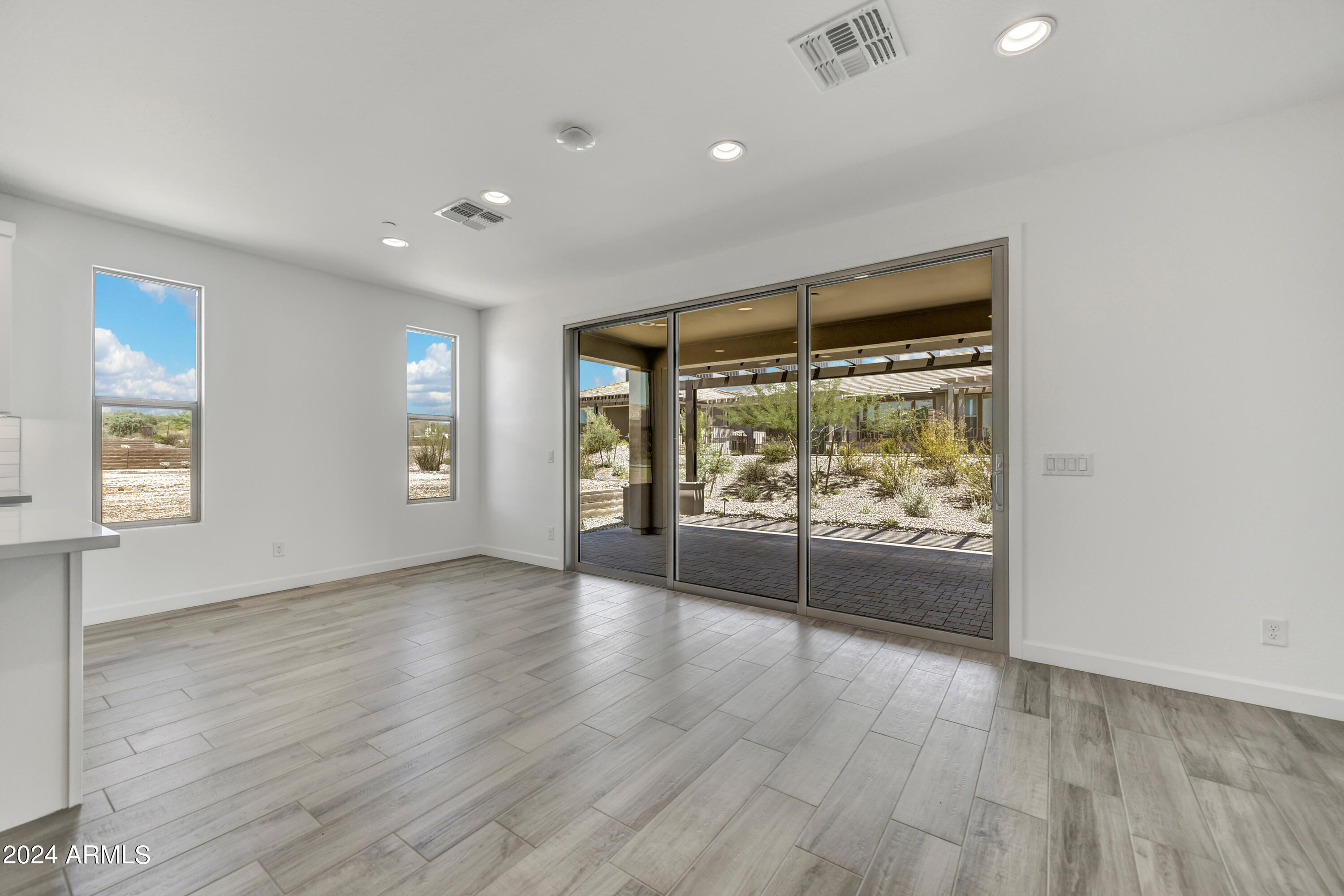 18238 East Coronado Cave Court Rio Verde, AZ 85263 - Photo 13 of 45 an empty room with wooden floor and windows