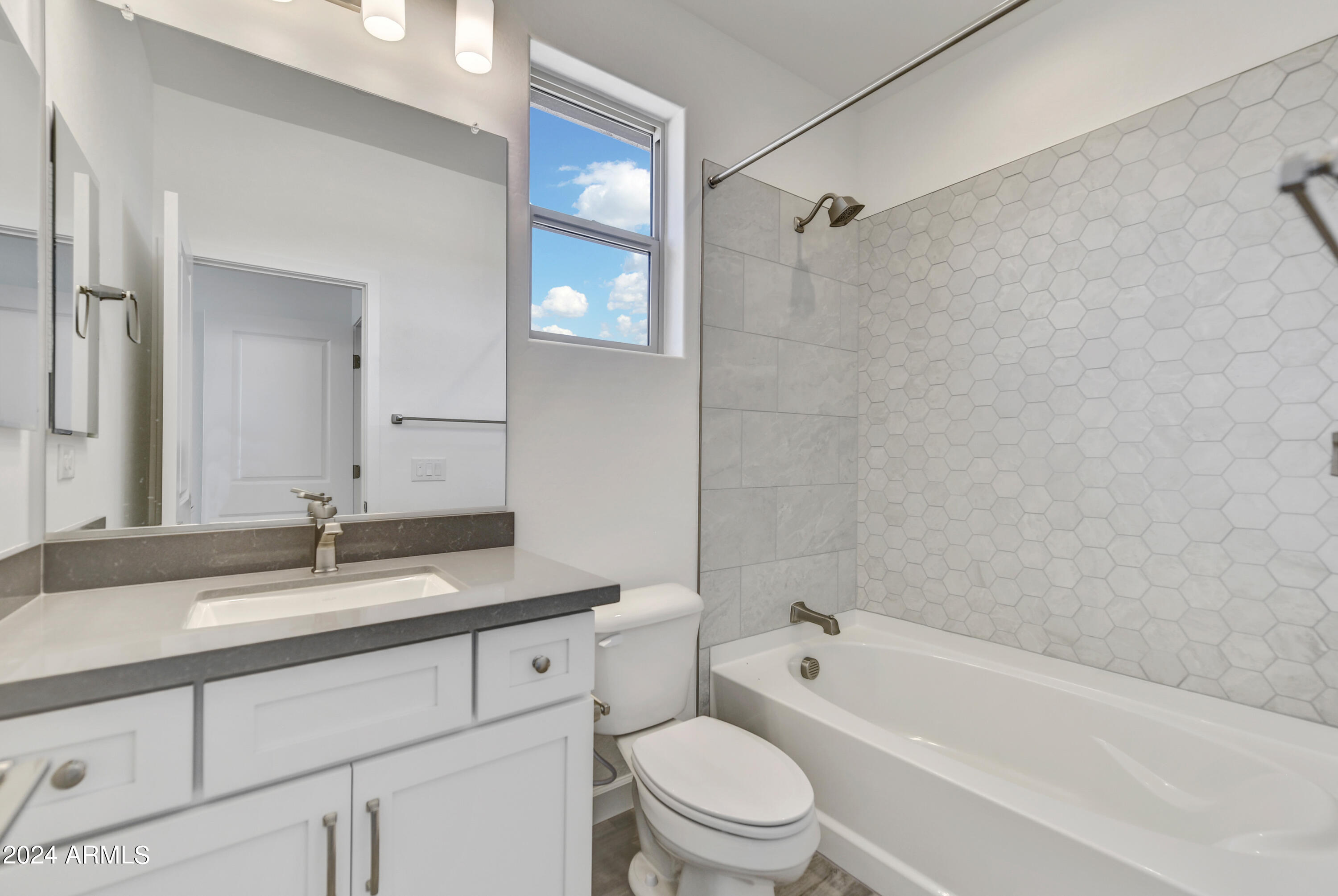 18238 East Coronado Cave Court Rio Verde, AZ 85263 - Photo 18 of 45 a bathroom with a granite countertop bathtub shower sink vanity mirror and toilet