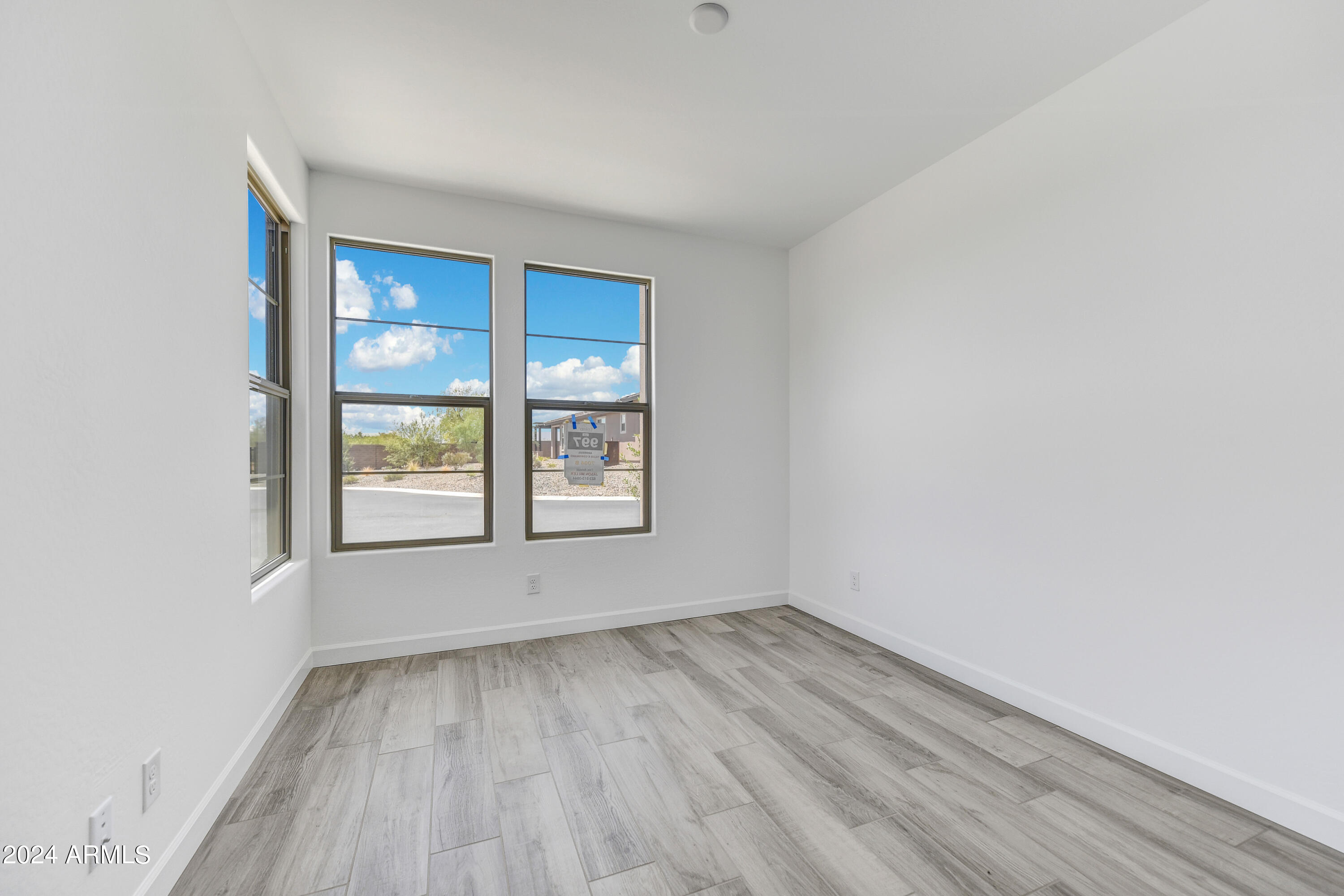 18238 East Coronado Cave Court Rio Verde, AZ 85263 - Photo 20 of 45 an empty room with wooden floor and windows