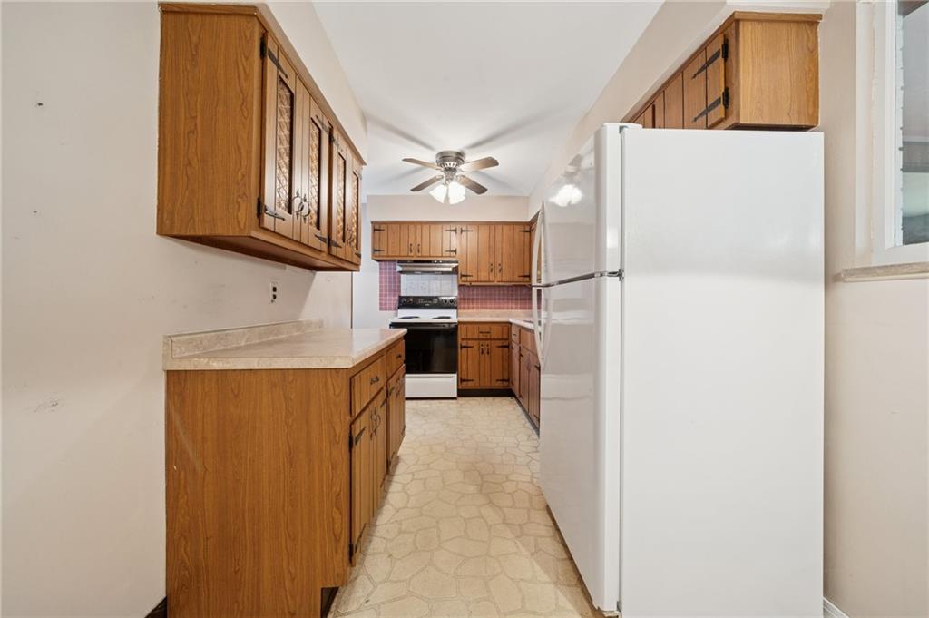 49 Millersdale Road Jeannette, PA 15644 - Photo 11 of 33 a kitchen with stainless steel appliances granite countertop a refrigerator a oven and a sink with cabinets
