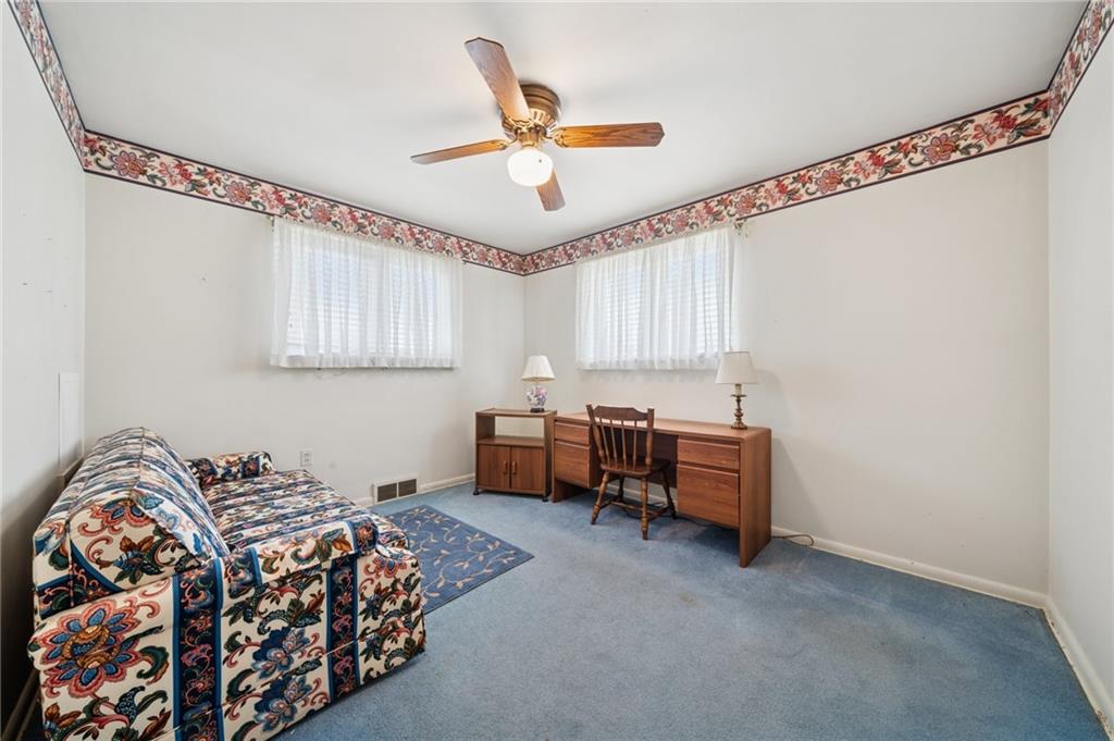 49 Millersdale Road Jeannette, PA 15644 - Photo 16 of 33 a bedroom with a bed and a chandelier