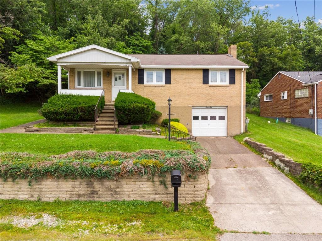 49 Millersdale Road Jeannette, PA 15644 - Photo 33 of 33 a front view of a house with garden