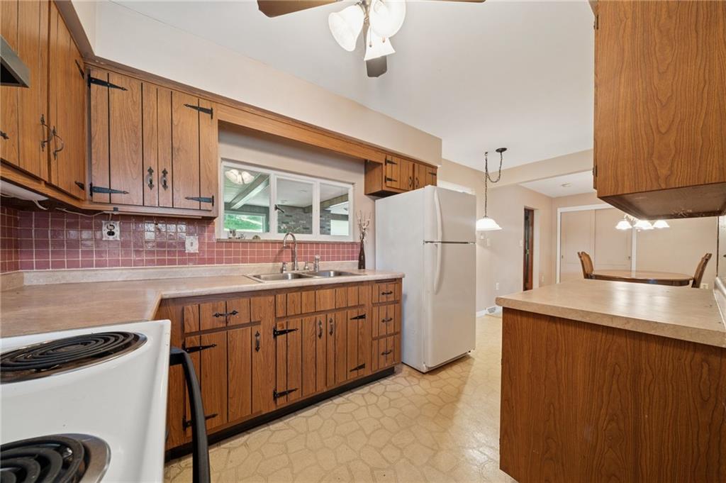 49 Millersdale Road Jeannette, PA 15644 - Photo 9 of 33 a kitchen with stainless steel appliances granite countertop a sink a stove and refrigerator