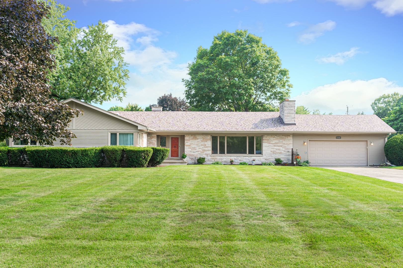 226 Windsor Drive DeKalb, IL 60115 - Photo 1 of 34 a view of a house with a yard and potted plants