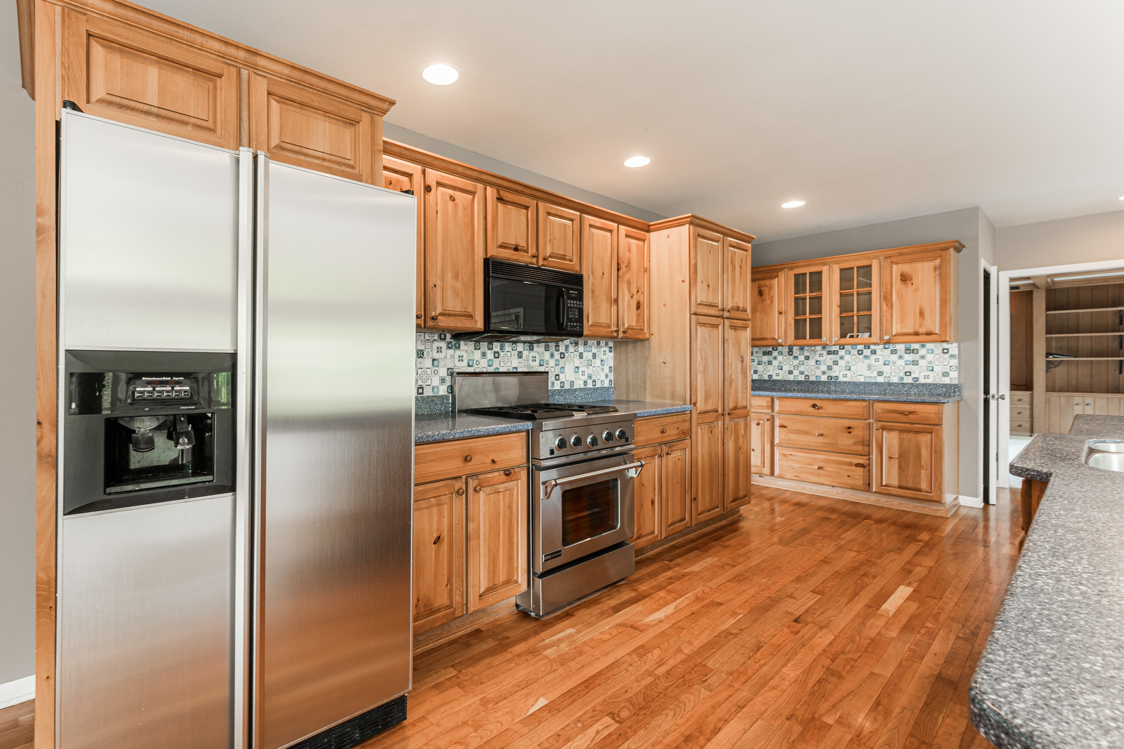 226 Windsor Drive DeKalb, IL 60115 - Photo 11 of 34 a kitchen with stainless steel appliances granite countertop a refrigerator and a stove top oven