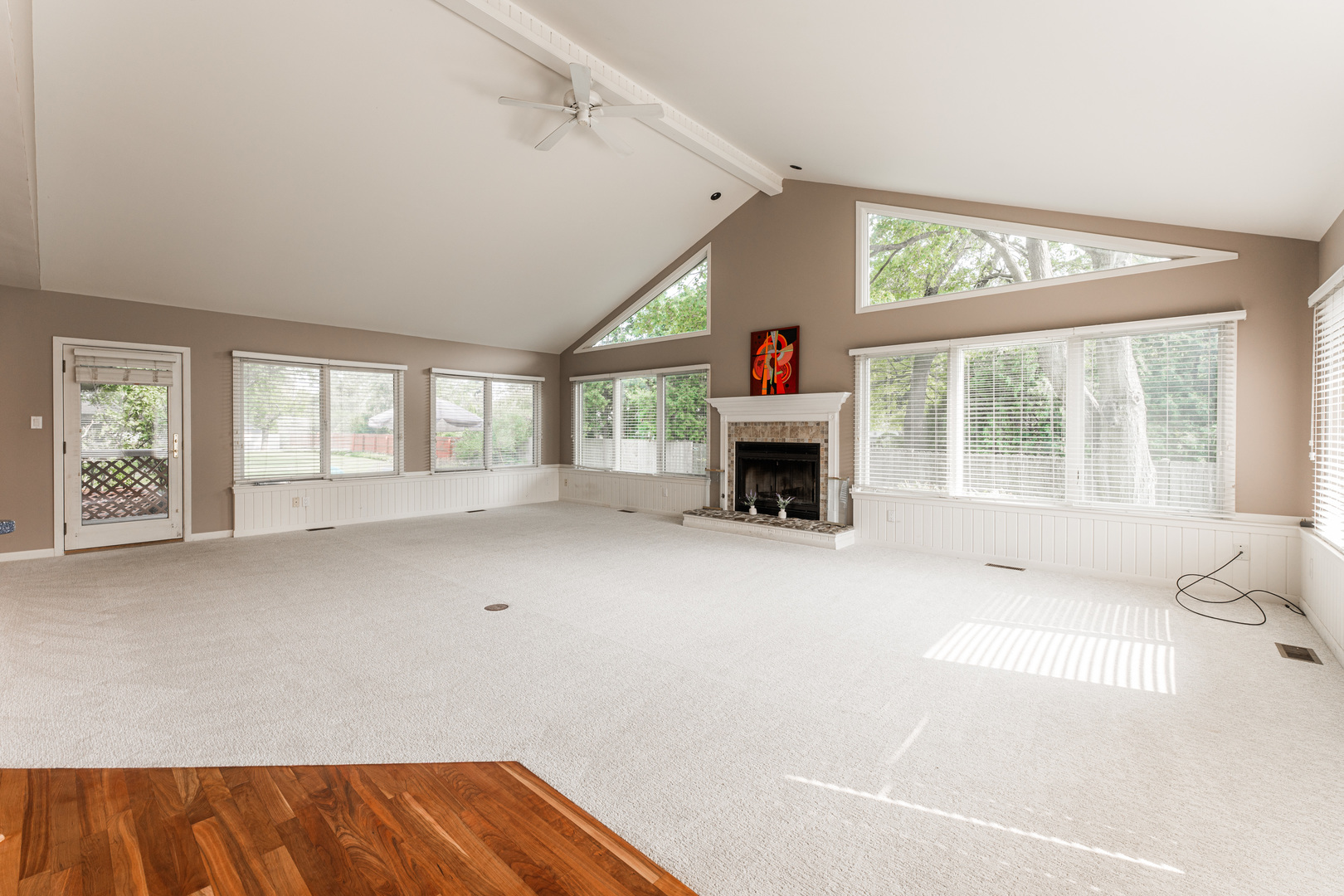226 Windsor Drive DeKalb, IL 60115 - Photo 12 of 34 a view of an empty room with a fireplace and a window