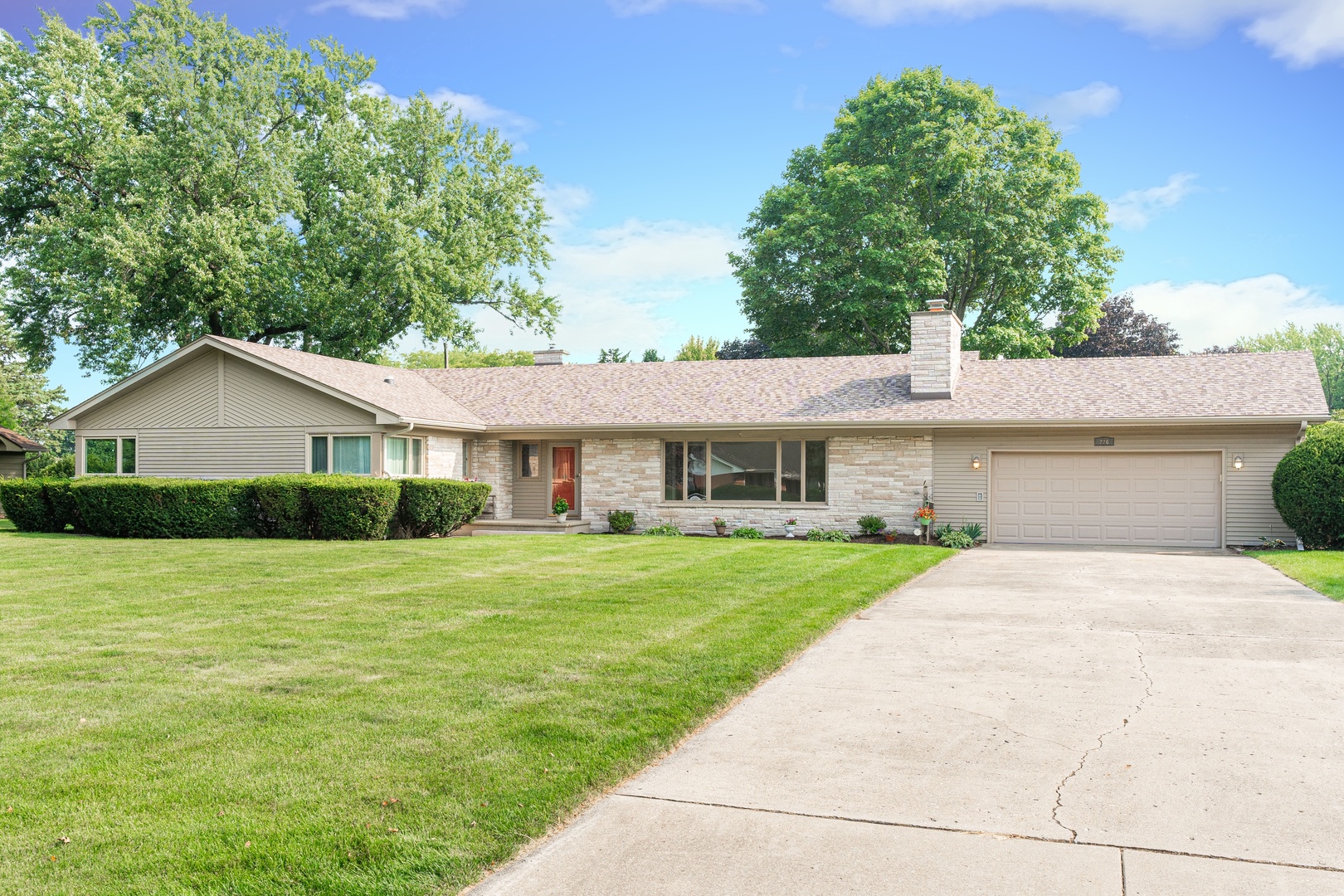 226 Windsor Drive DeKalb, IL 60115 - Photo 2 of 34 a front view of a house with a yard and trees