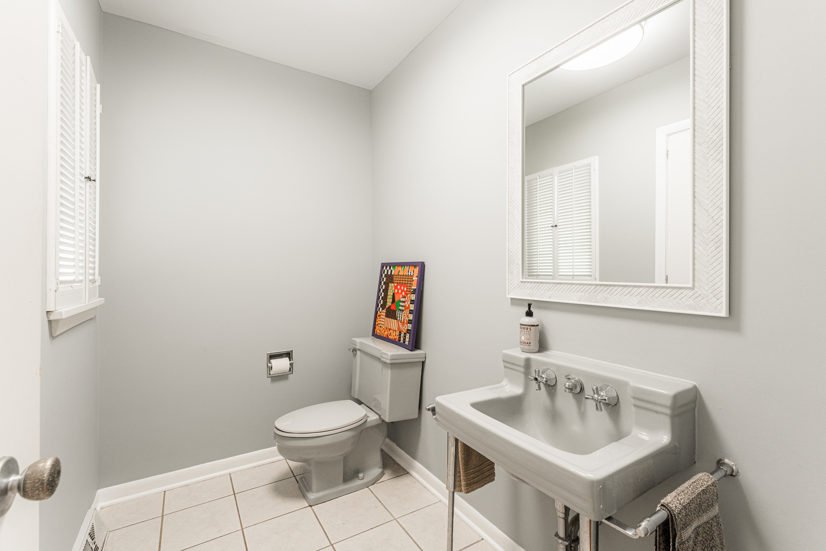226 Windsor Drive DeKalb, IL 60115 - Photo 26 of 34 a bathroom with a toilet a sink and mirror
