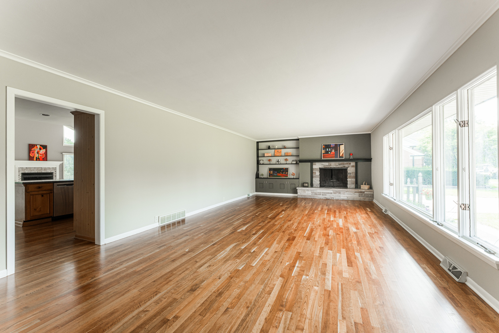226 Windsor Drive DeKalb, IL 60115 - Photo 3 of 34 a view of empty room with wooden floor and fireplace
