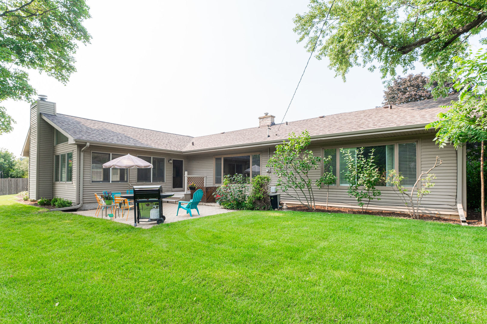 226 Windsor Drive DeKalb, IL 60115 - Photo 32 of 34 a front view of a house with a garden and porch