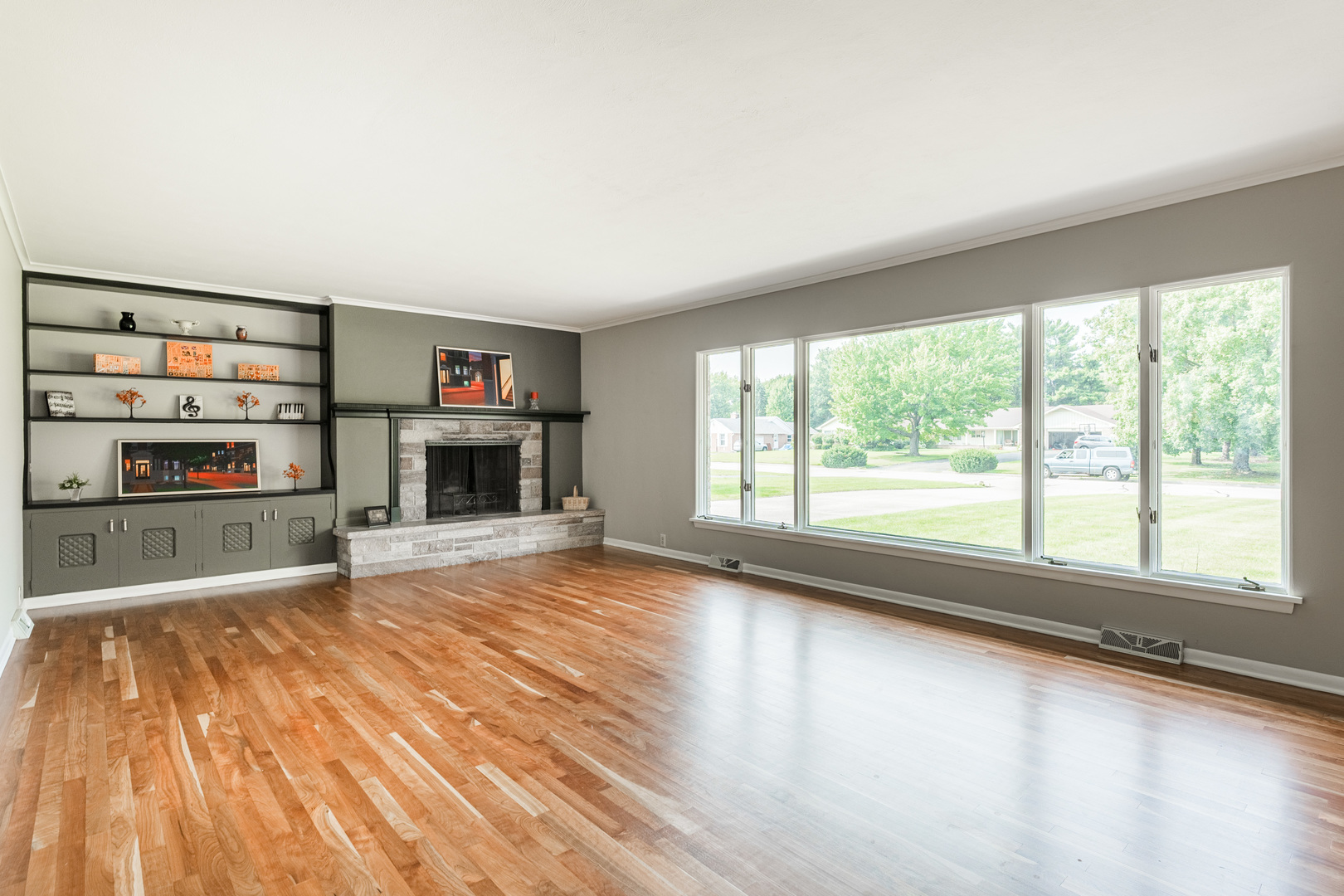 226 Windsor Drive DeKalb, IL 60115 - Photo 6 of 34 a view of empty room with wooden floor and fireplace