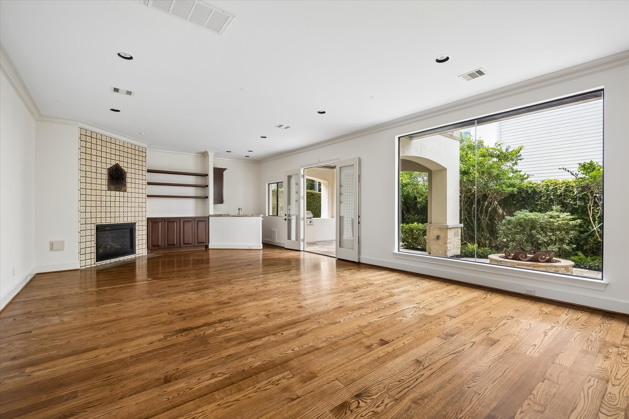 2246 Branard Street Houston, TX 77098 - Photo 16 of 40 Bright and inviting family room featuring generous windows, custom built-ins, and easy indoor-outdoor flow.