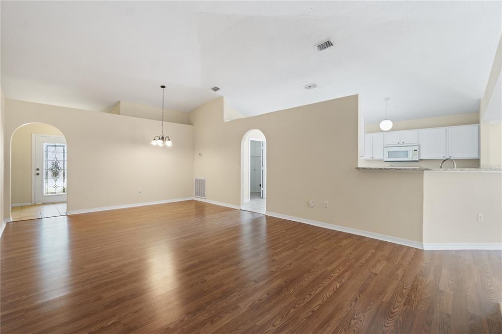 2339 Foxtree Road Tavares, FL 32778 - Photo 16 of 36 a view of empty room with wooden floor and window