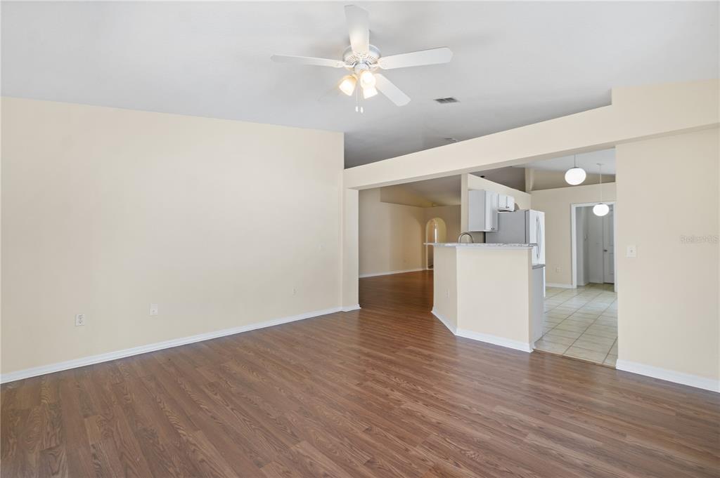 2339 Foxtree Road Tavares, FL 32778 - Photo 17 of 36 a view of a kitchen with wooden floor and a ceiling fan