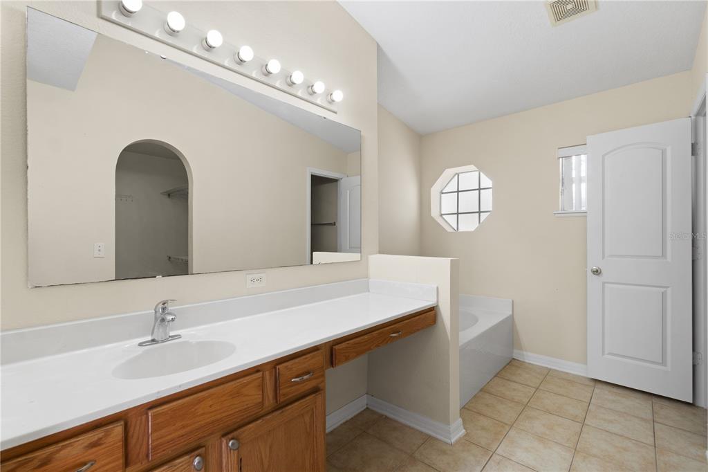 2339 Foxtree Road Tavares, FL 32778 - Photo 21 of 36 a bathroom with a sink and a mirror